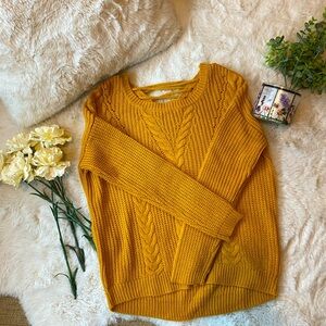Yellow/orange knit sweater with drawstring back.